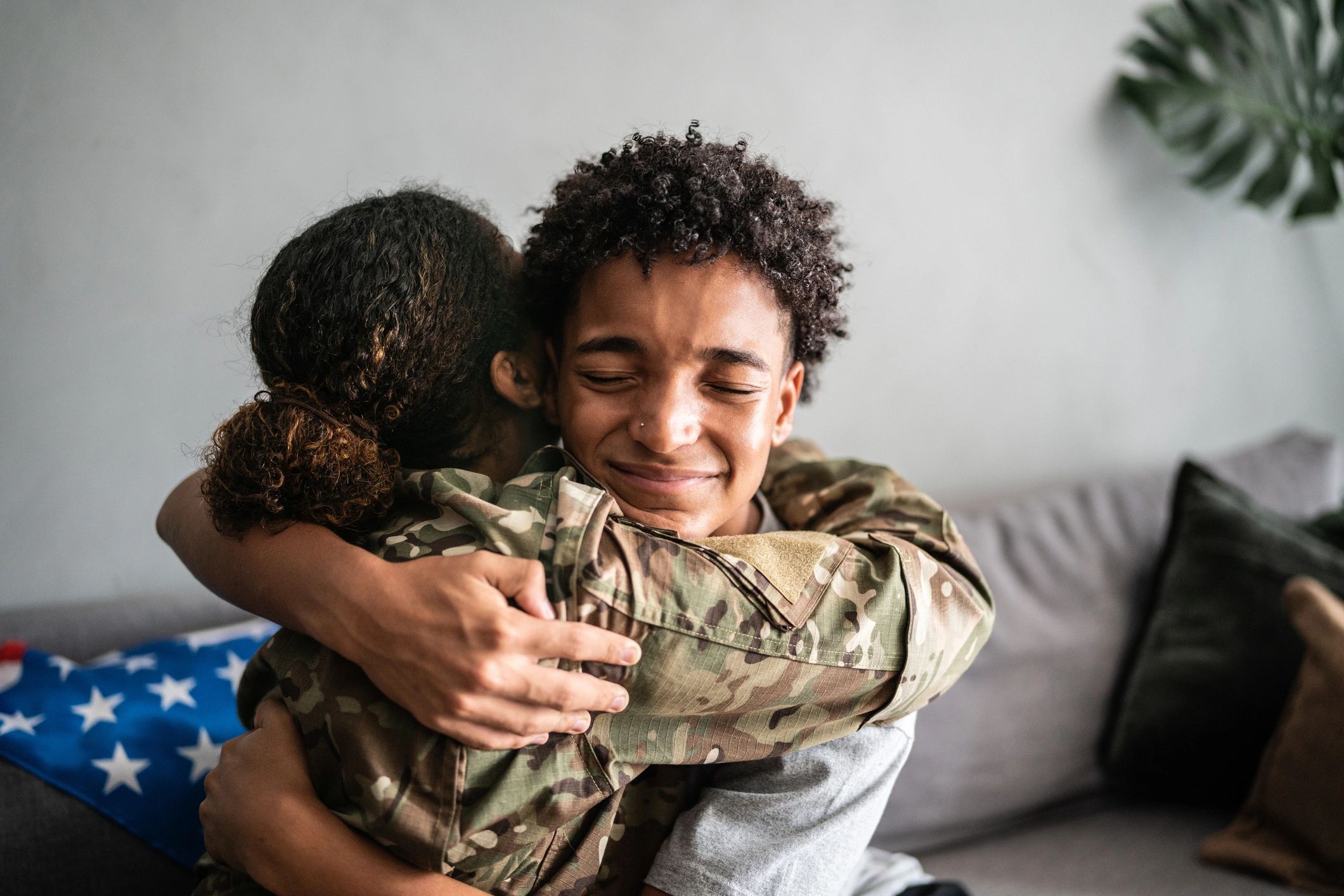 Military parent and child hugging representing family readiness and support