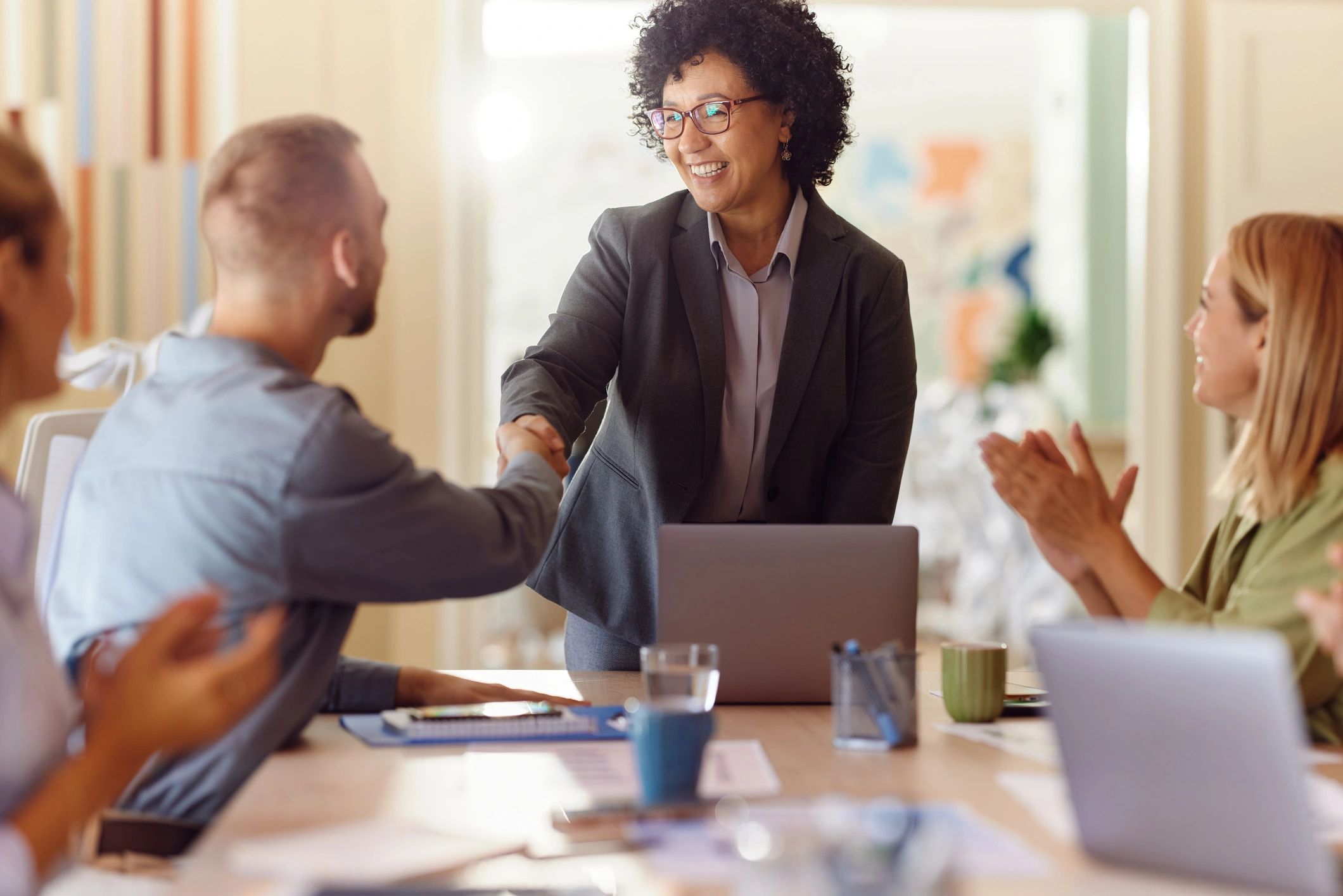 Colleagues shaking hands after reaching an agreement