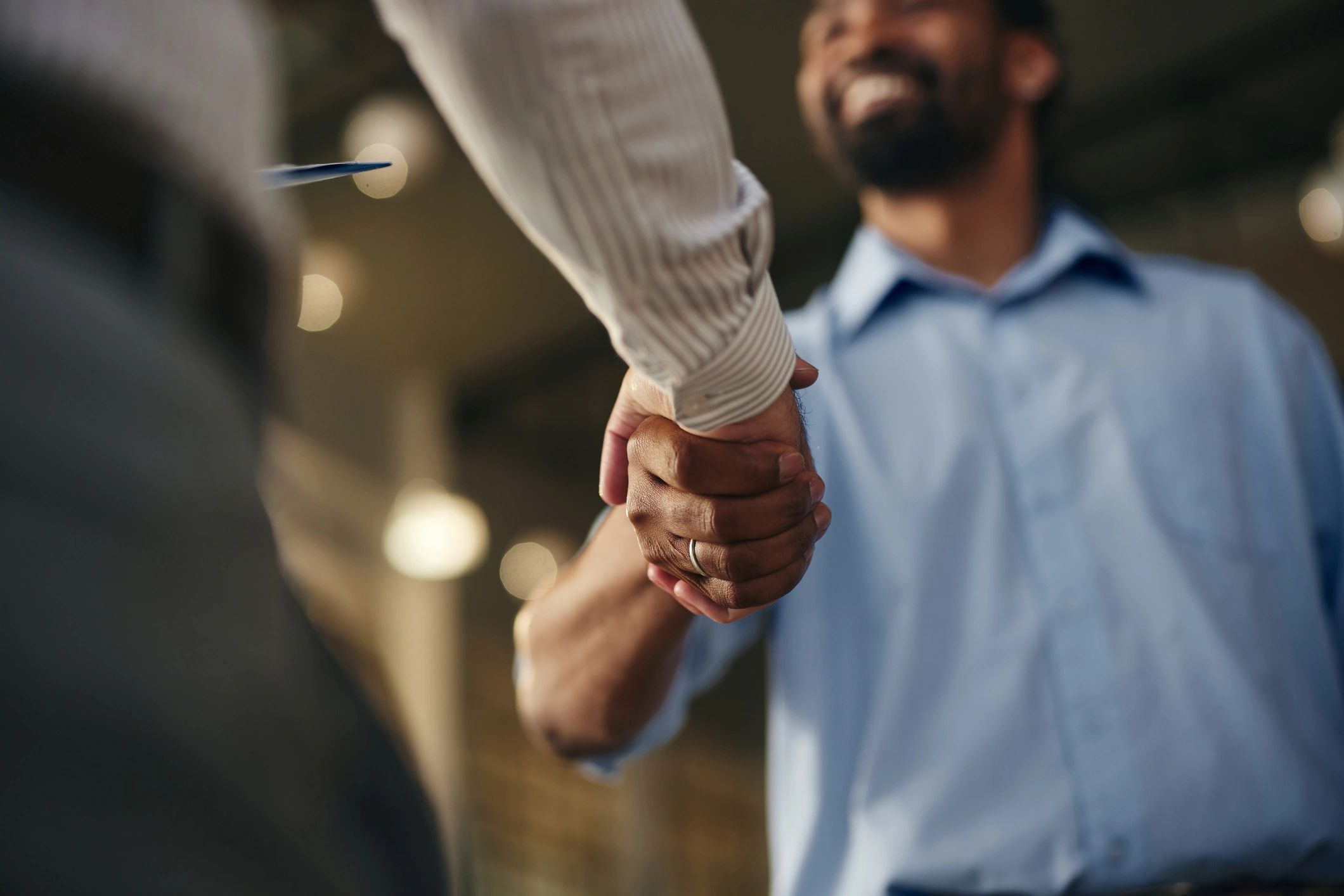 Professional handshake representing partnership and support